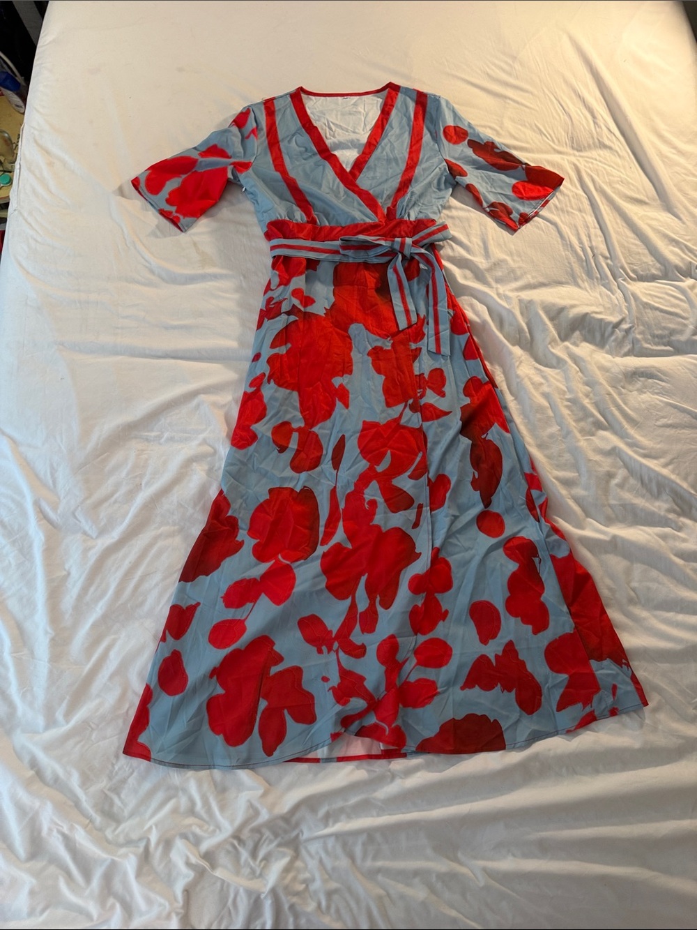 Red Floral Wrap Dress on Light Blue Background